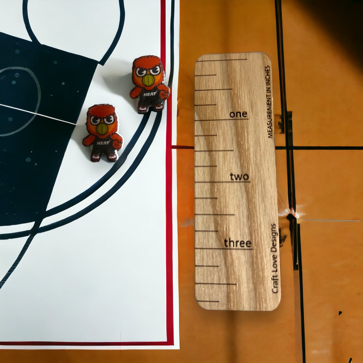 Playful Bernie Team SPIRIT stud earrings featuring Miami Heat’s iconic mascot. Bold red design makes a statement for basketball fans.