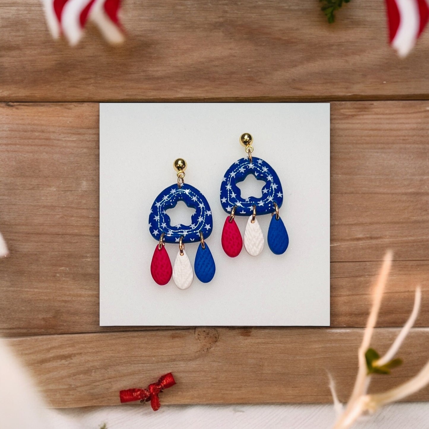 Unique 4th of July polymer clay dangle earrings with a festive red, white, and blue design, perfect for holiday celebrations.
