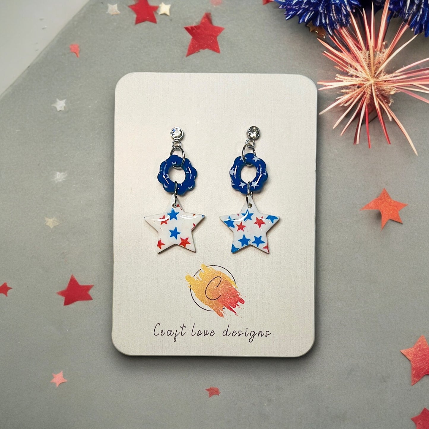 Polymer clay star dangle earrings featuring red and blue stars with rhinestone studs, perfect for 4th of July and patriotic events.