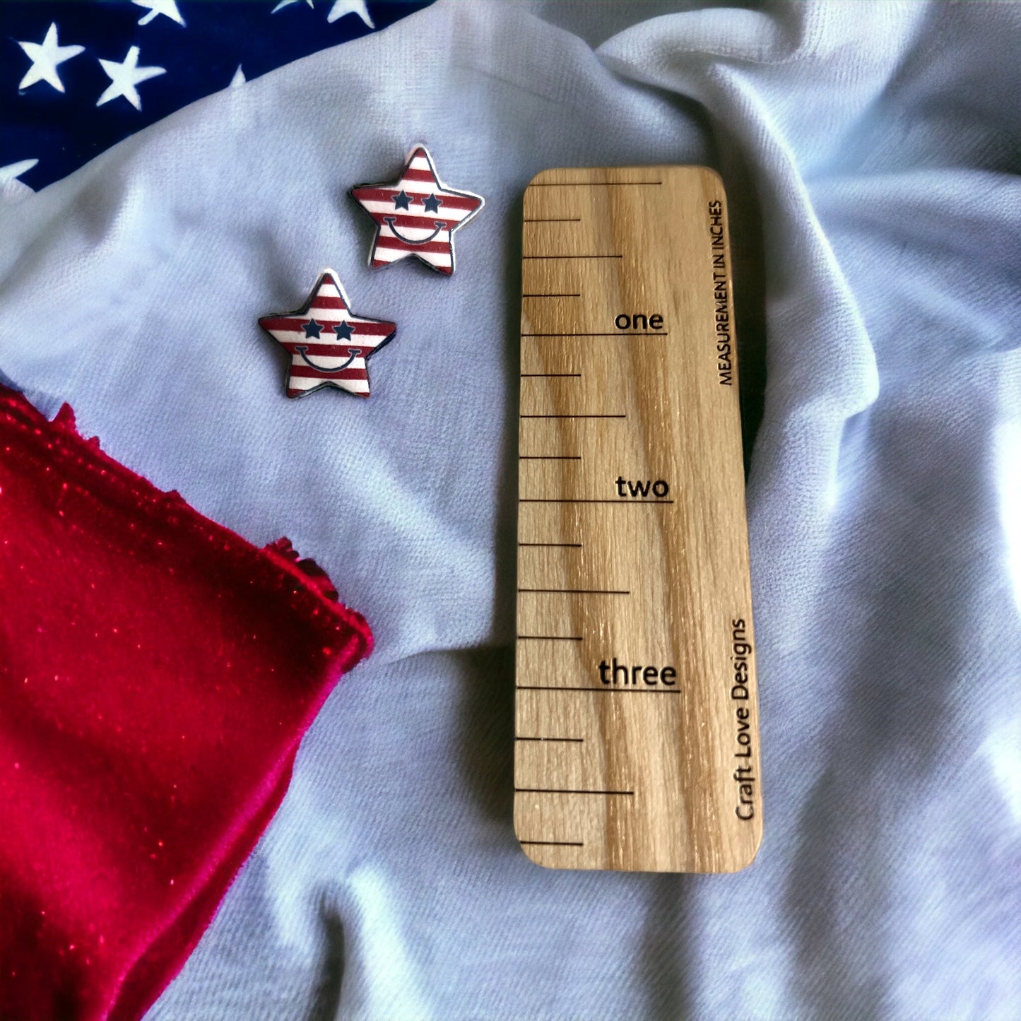 Red, white, and blue patriotic star-shaped earrings featuring a smiling design and playful stars, perfect for celebrations.