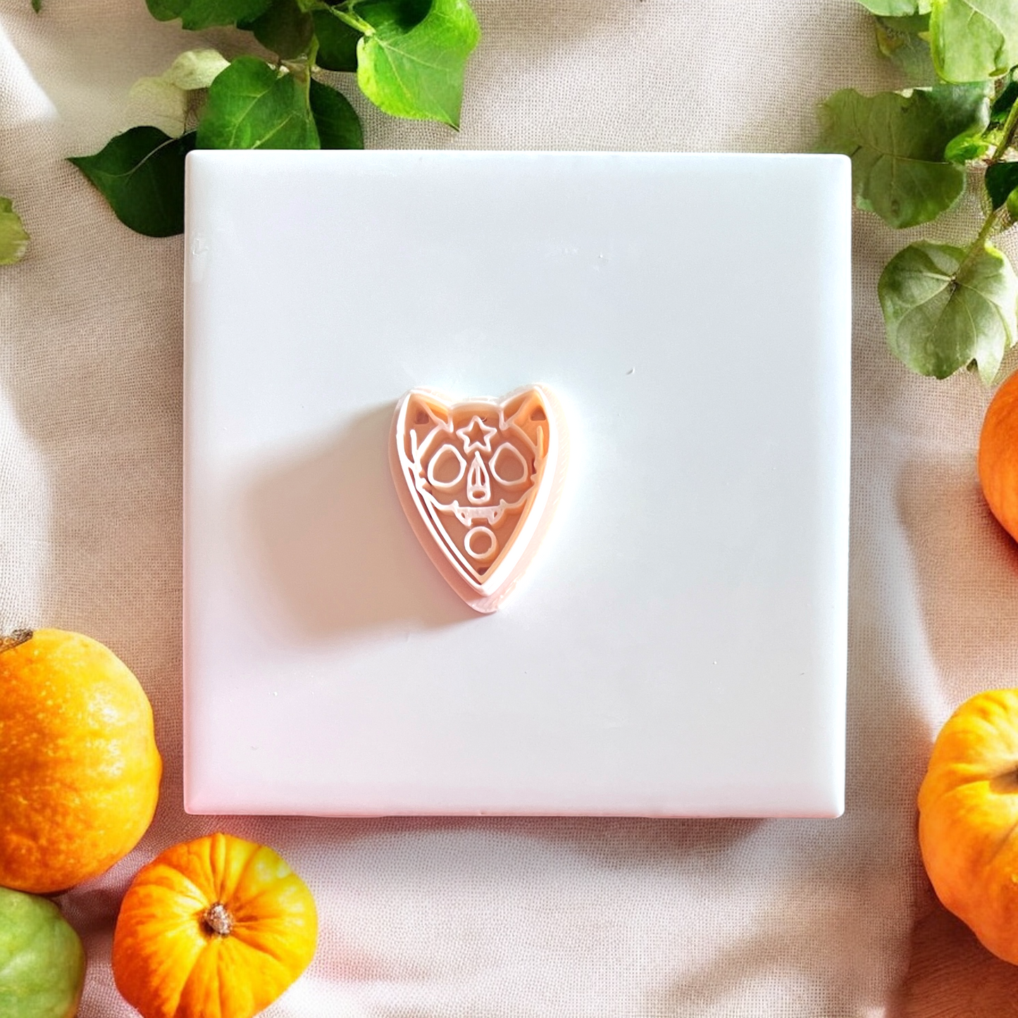 Pink sugar skull cat cutter shown close-up with festive fall styling