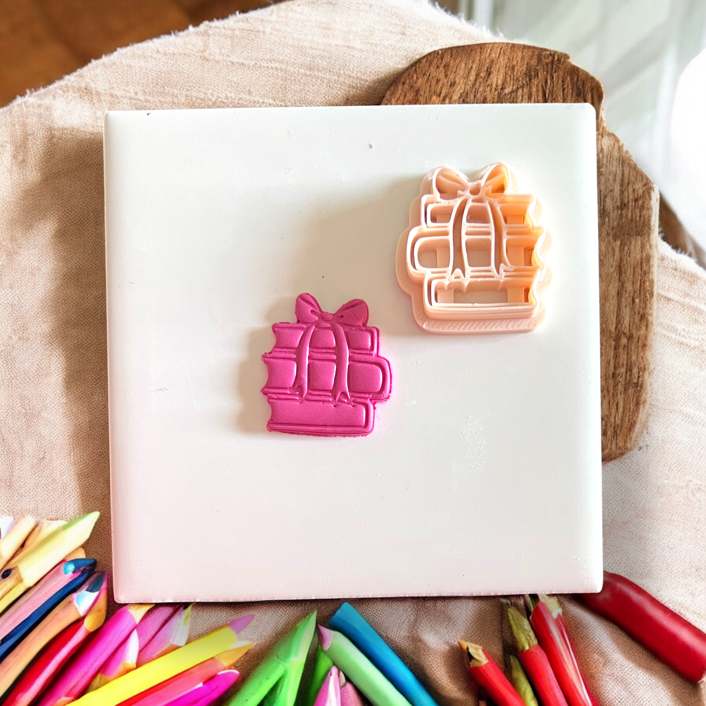 Stack of books with bow pink cut out and cutter