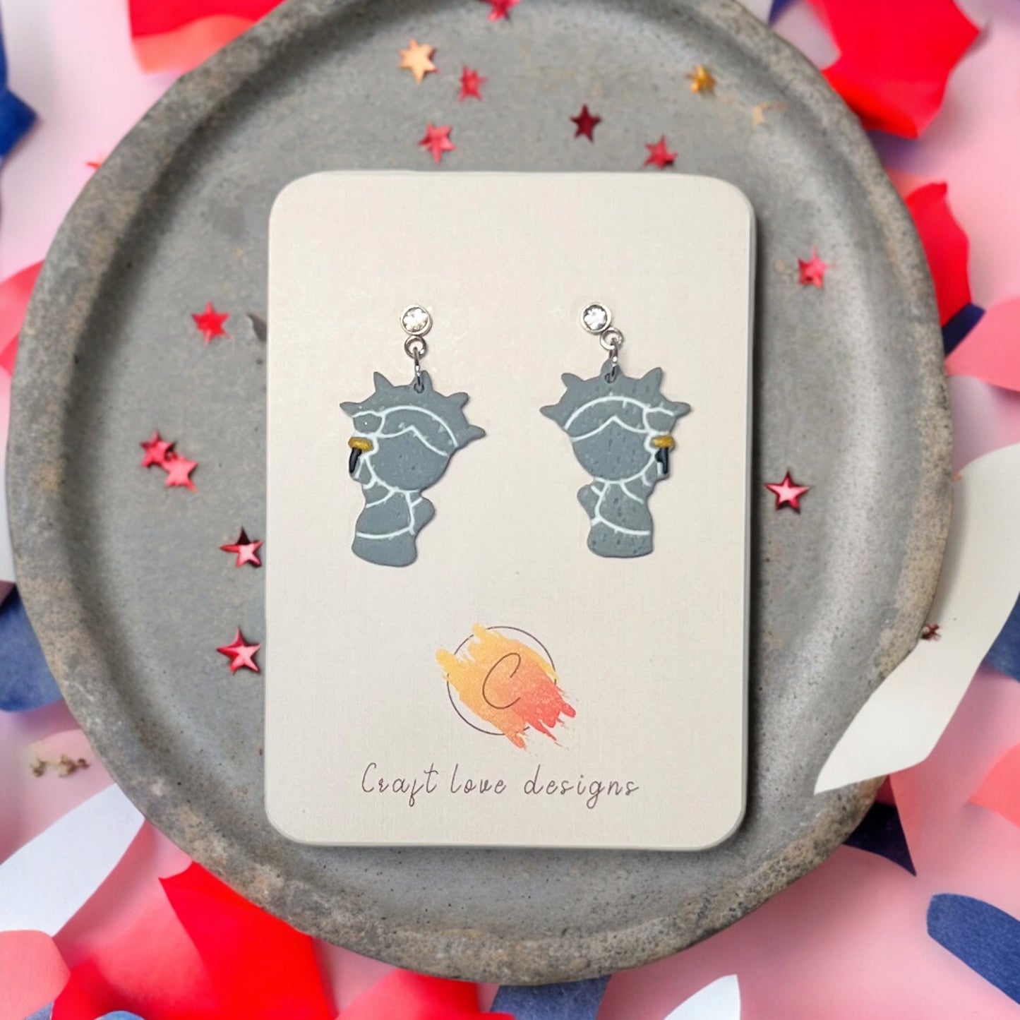 Handmade gray Statue of Liberty dangle earrings featuring rhinestone studs and gold torch details, perfect for patriotic occasions.