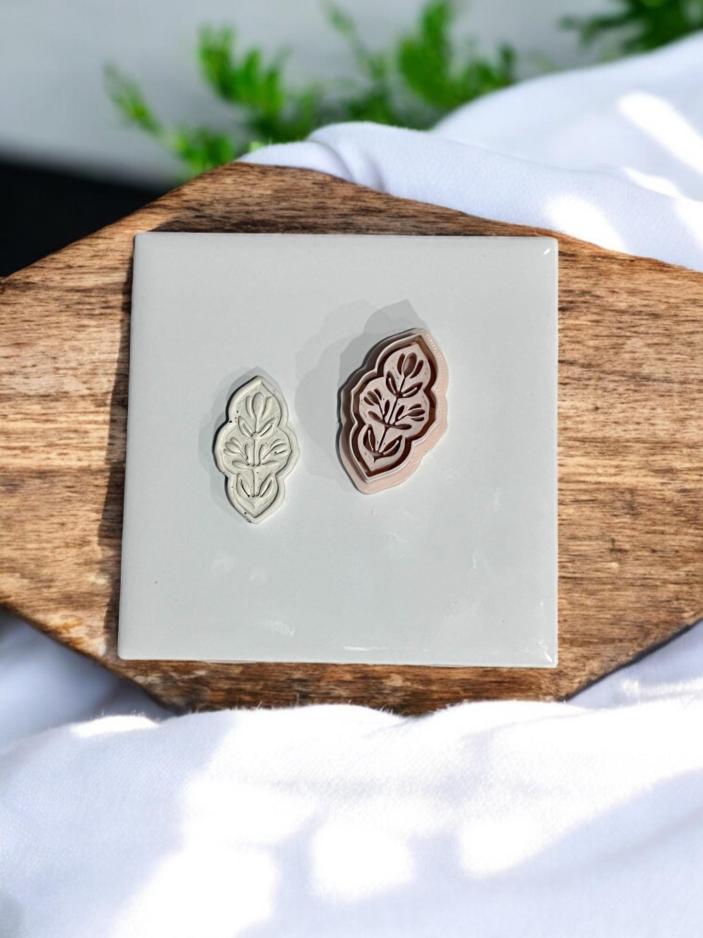 Embossed clay cutter shown next to matching pressed clay result