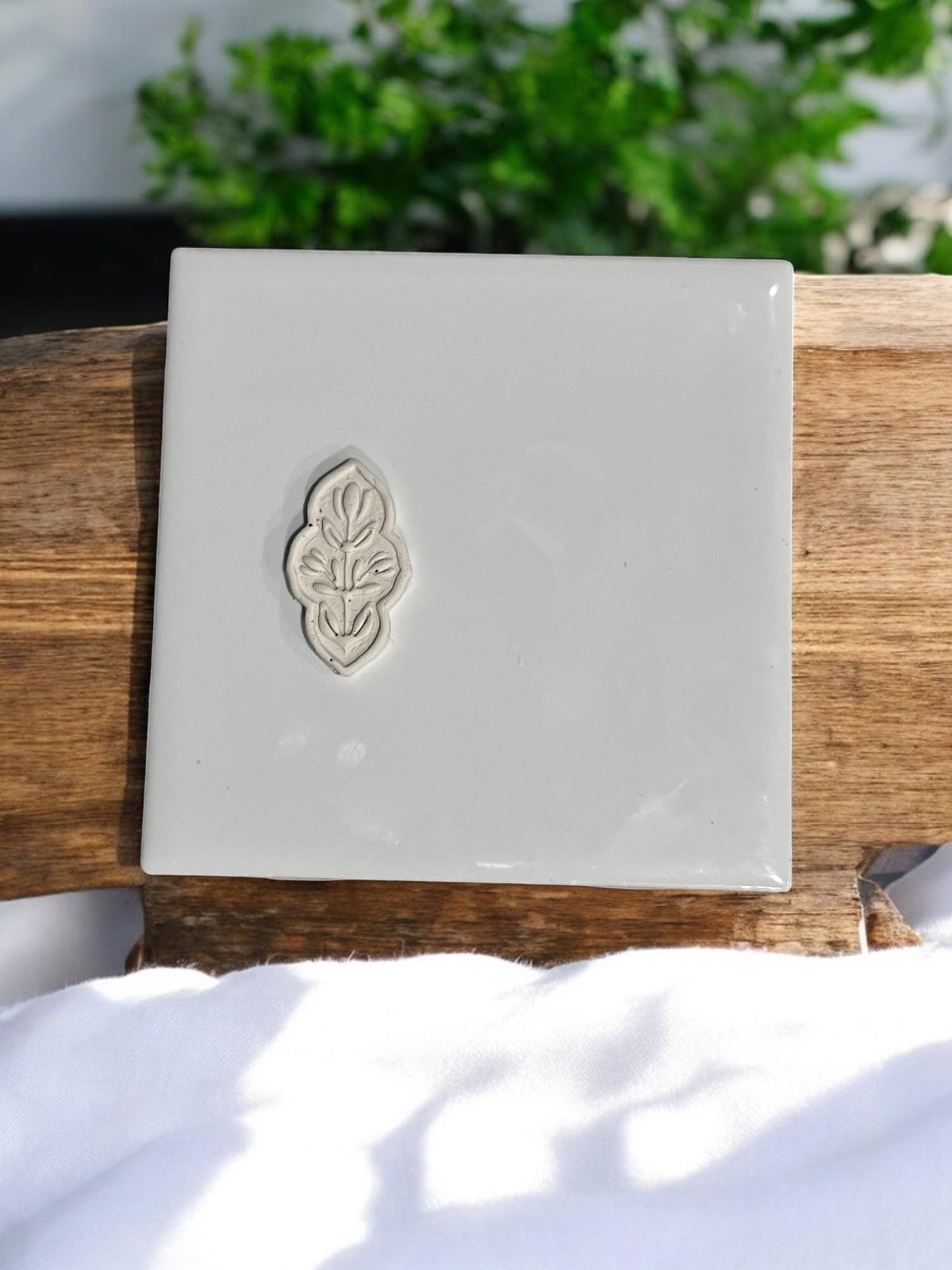Pressed clay howing cutter impression with leaf-style design