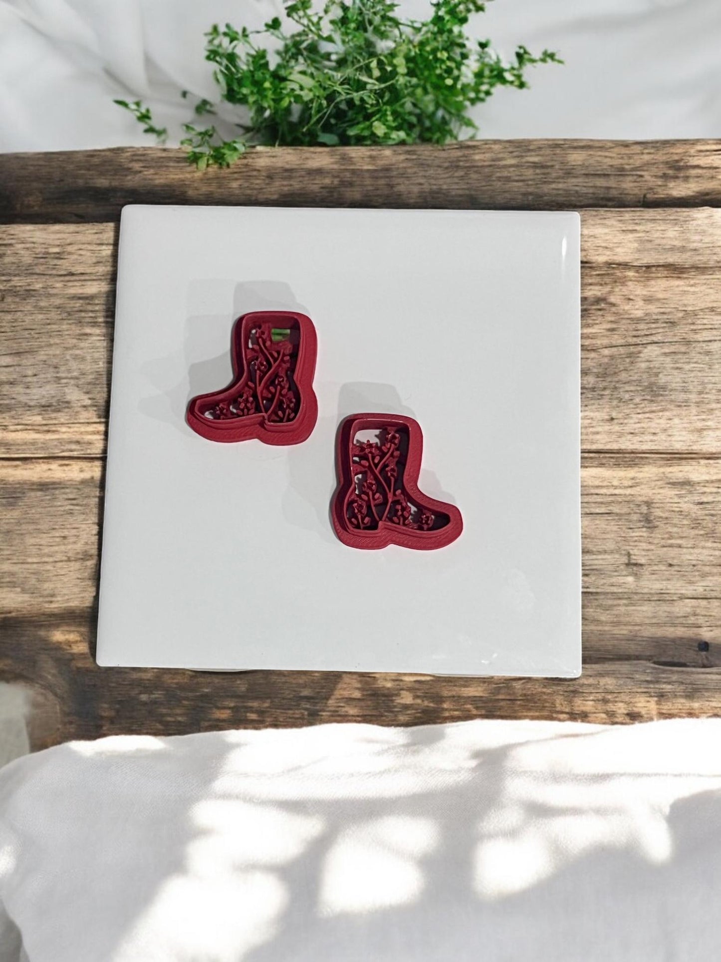 Two boot cutters in mirror orientation on white ceramic tile