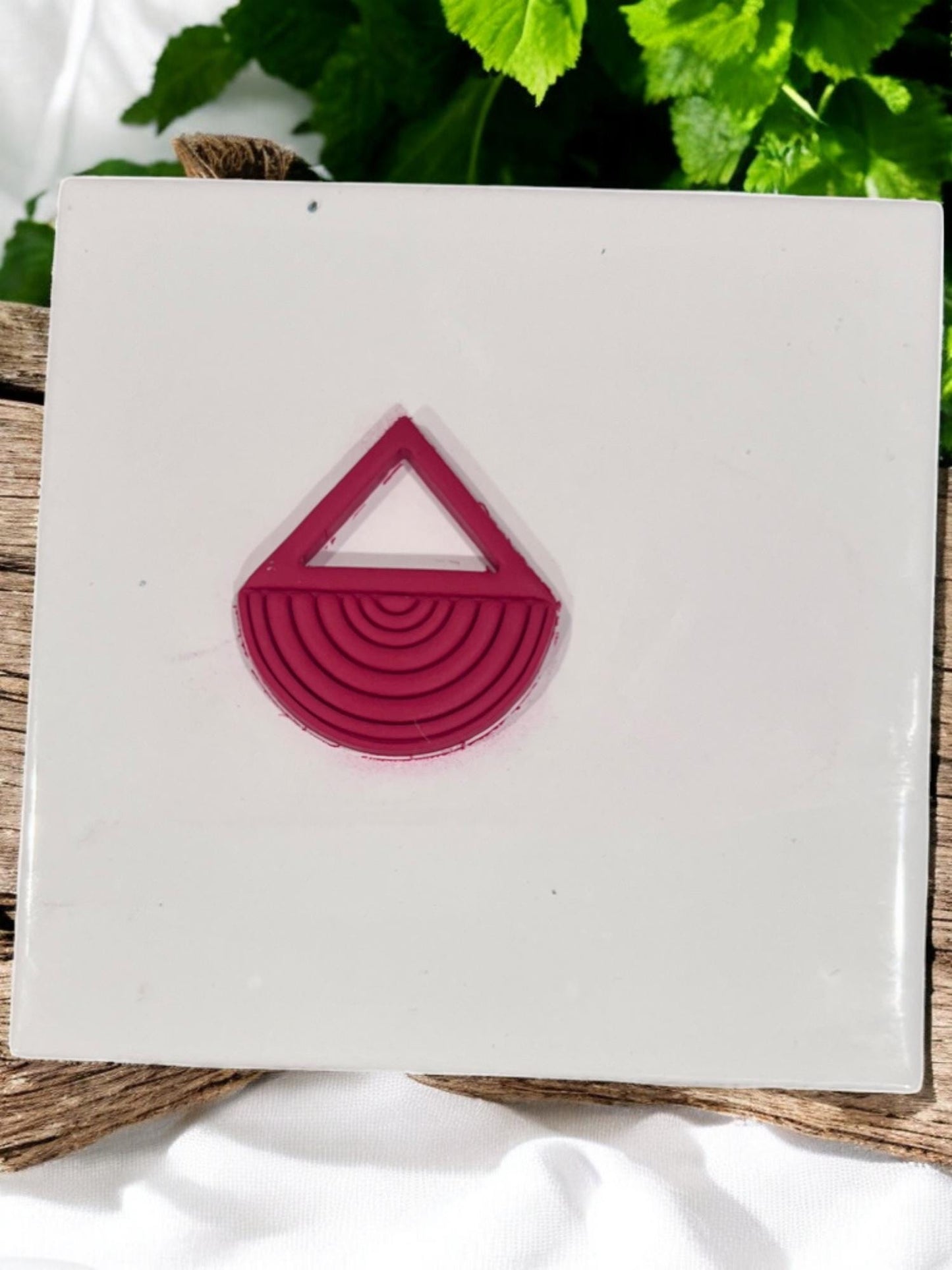 Finished clay shape with triangle and half-circle detail
