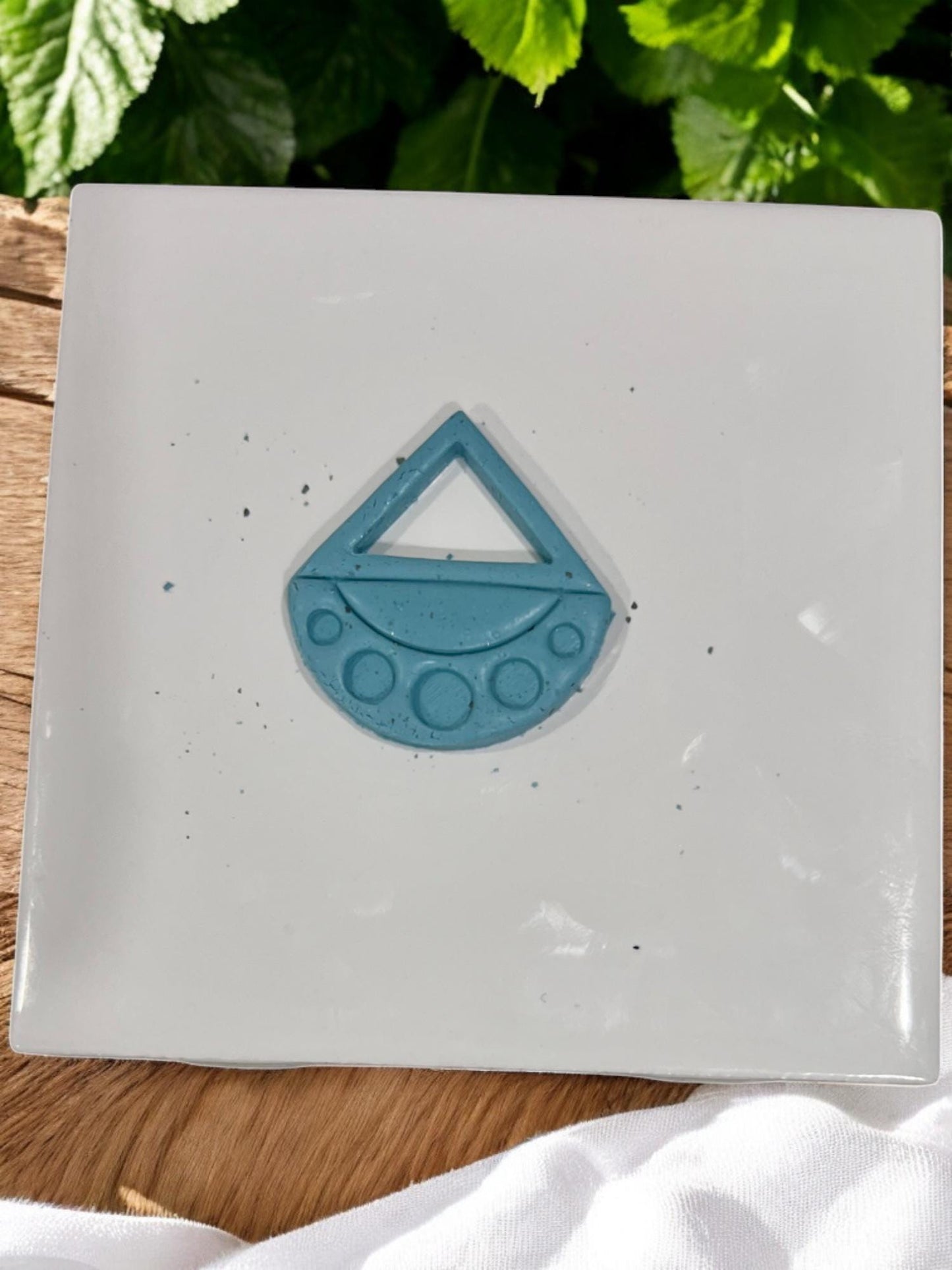Cut blue clay shape showing triangle and dot cutouts from boho drop cutter