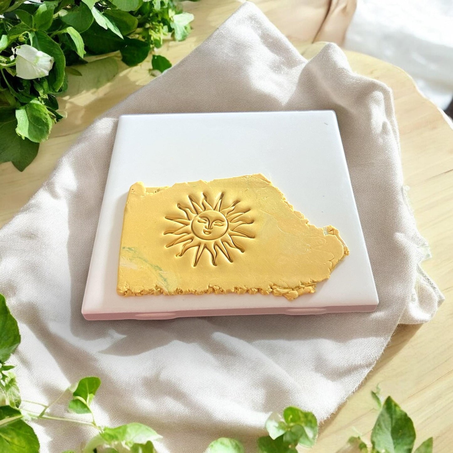 sun face clay imprint on yellow polymer
