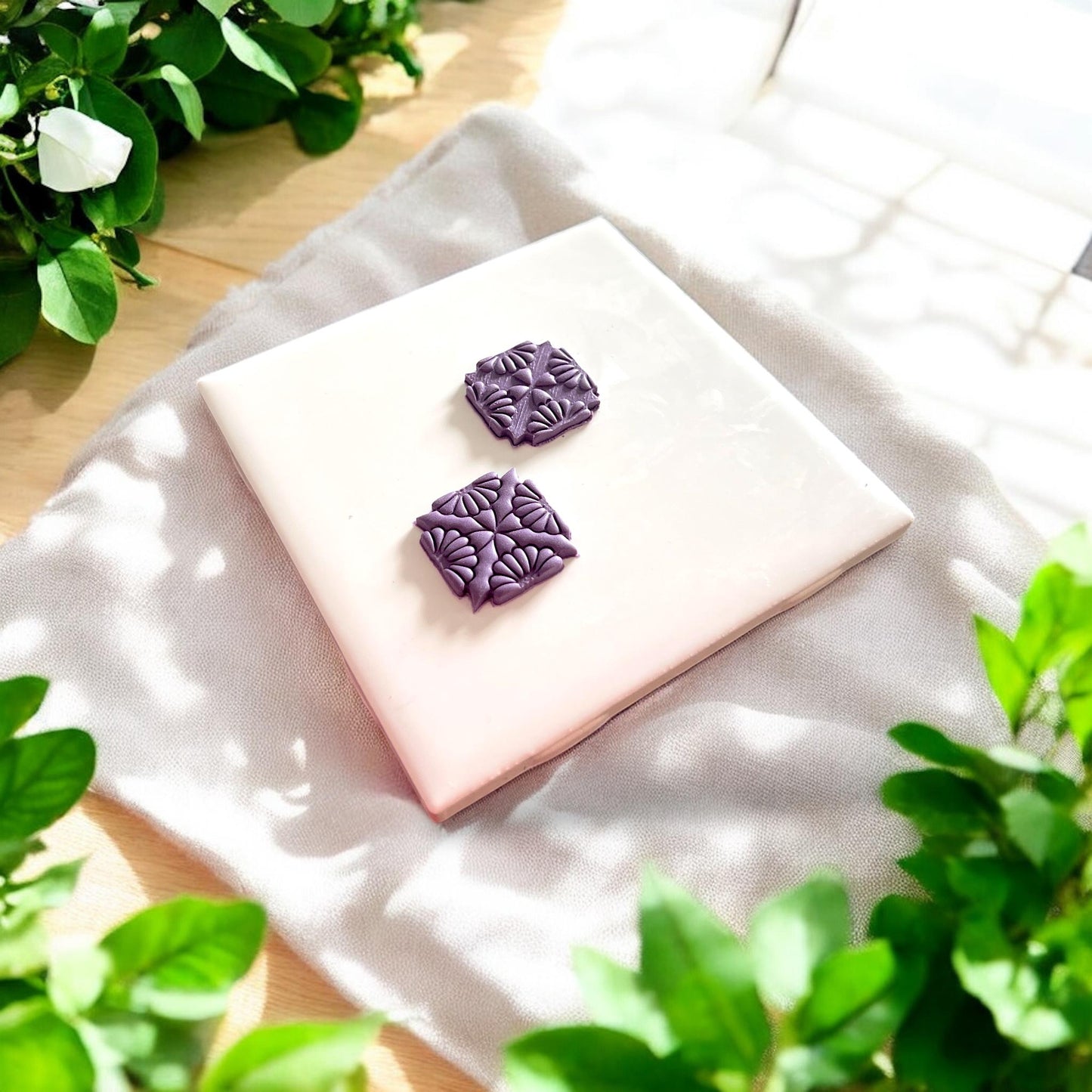 two floral clay pieces on tile