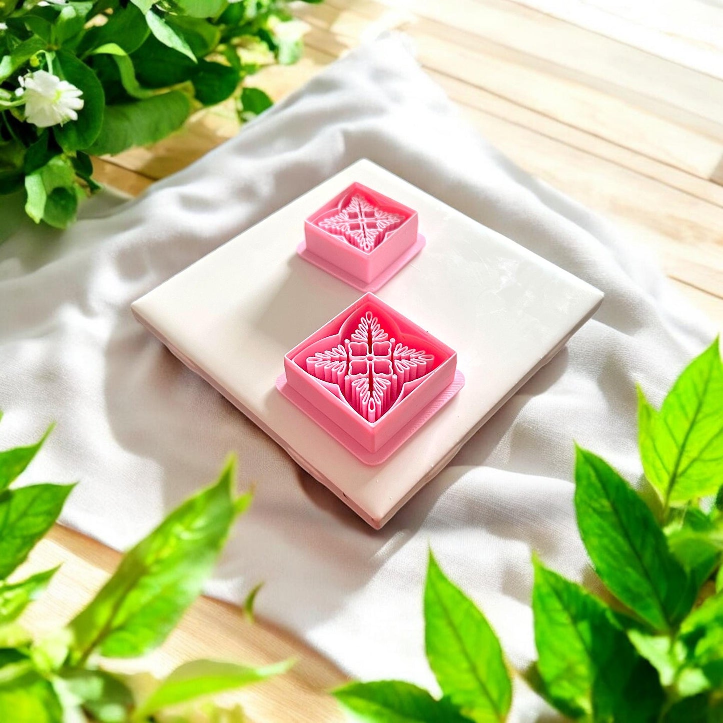 two pink floral square cutters shown on tile