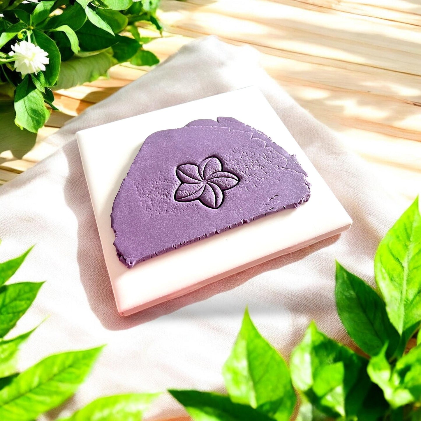 purple clay slab with plumeria flower imprint