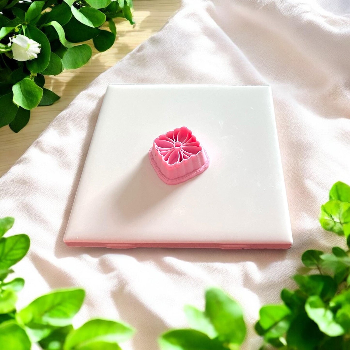 pink geometric floral cutter on tile