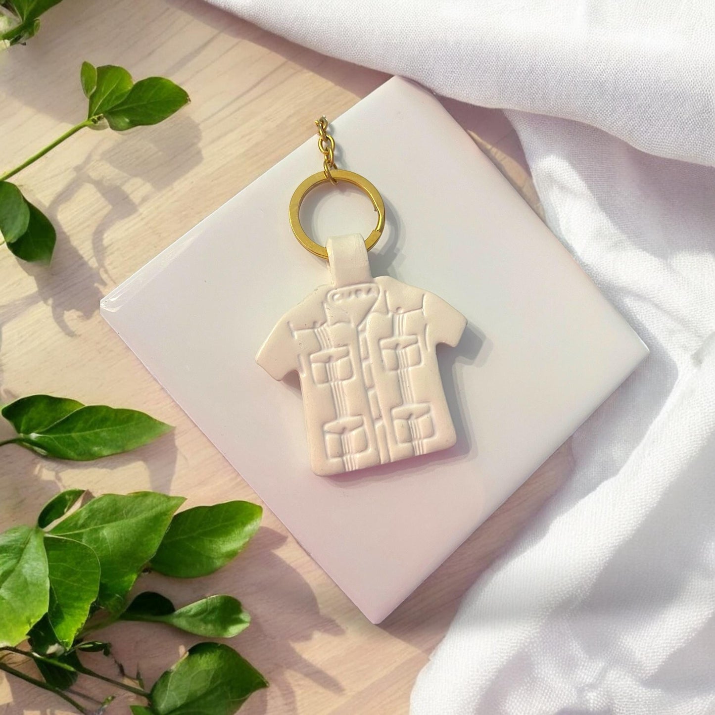 closeup of guayabera keychain in white clay