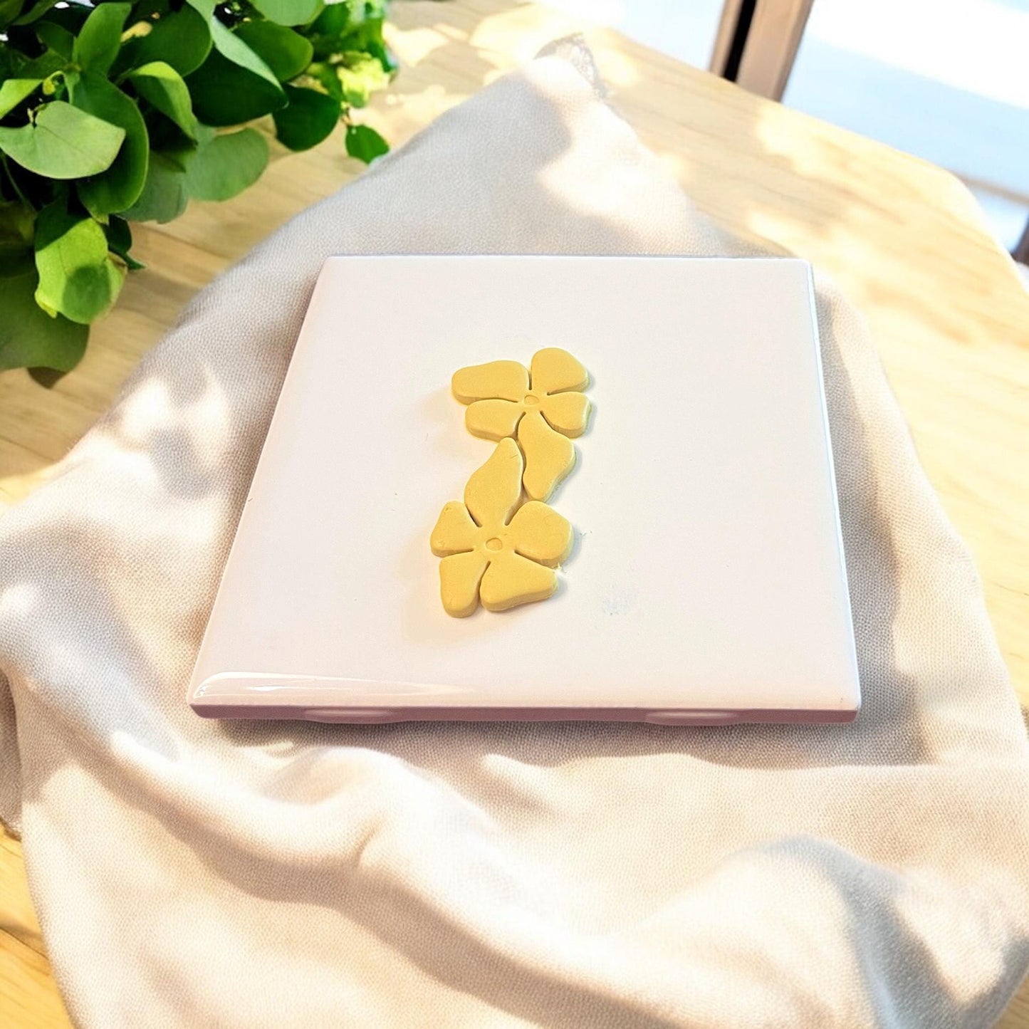 A pair of finished clay flower pieces with interlocking petals, perfect for making floral dangle earrings