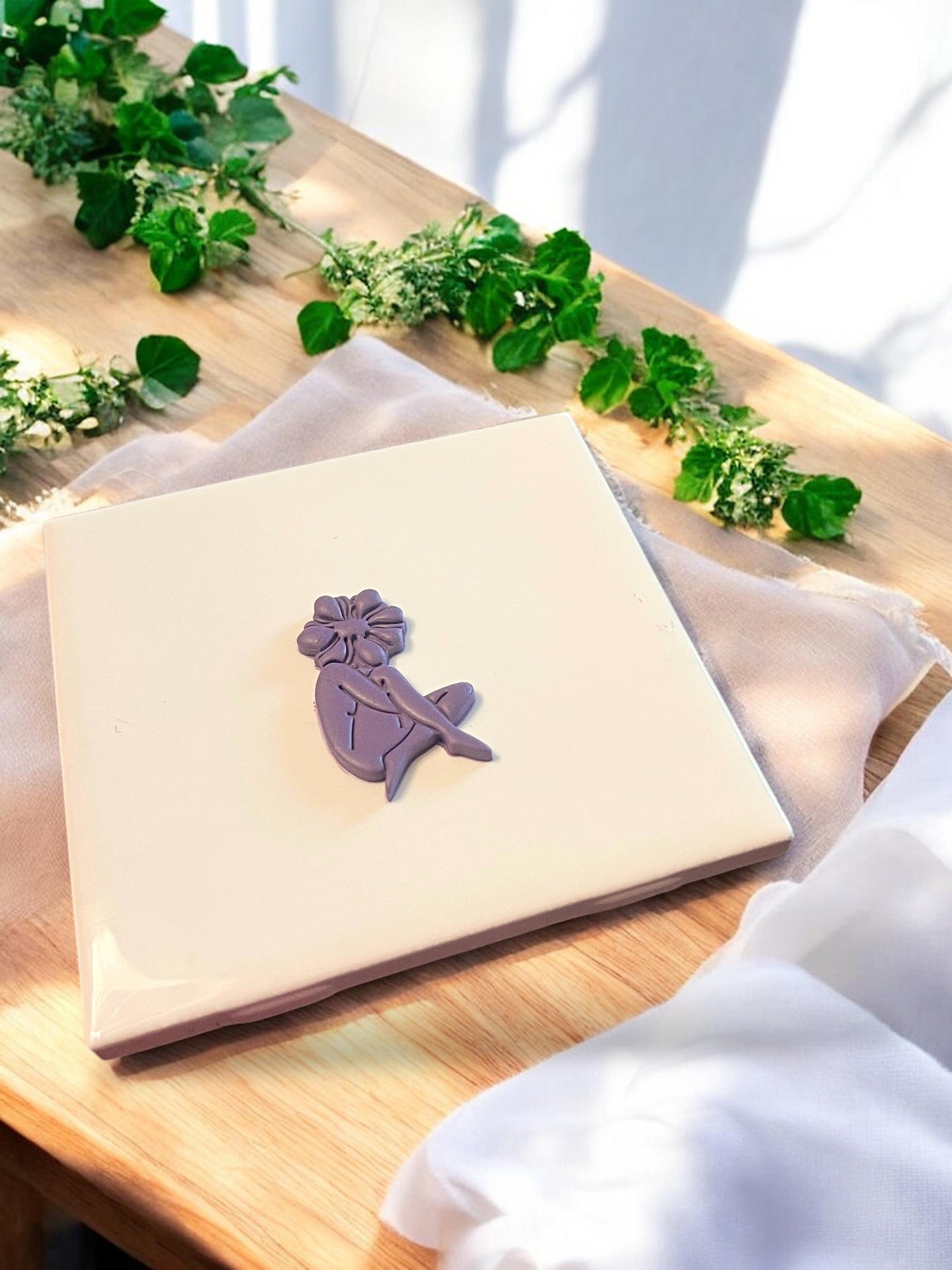 Floral girl silhouette clay shape cut using a polymer clay cutter designed for whimsical dangles or charm making