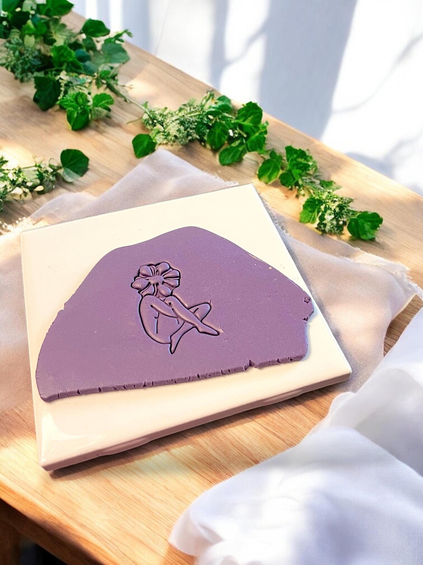 A polymer clay cutter featuring a floral head girl design used to create unique handmade earring or pendant shapes