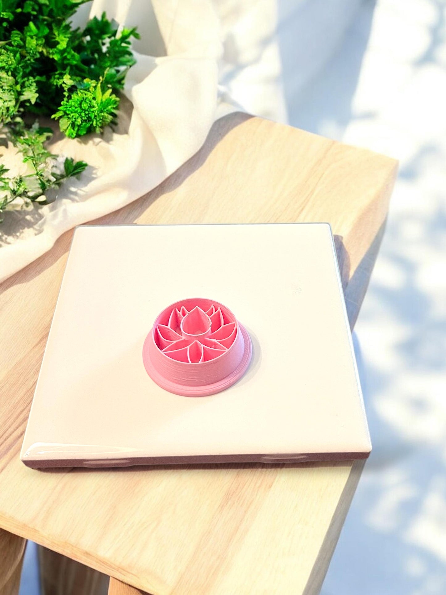 Top view of round lotus clay cutter with mandala petal details for earring or jewelry making