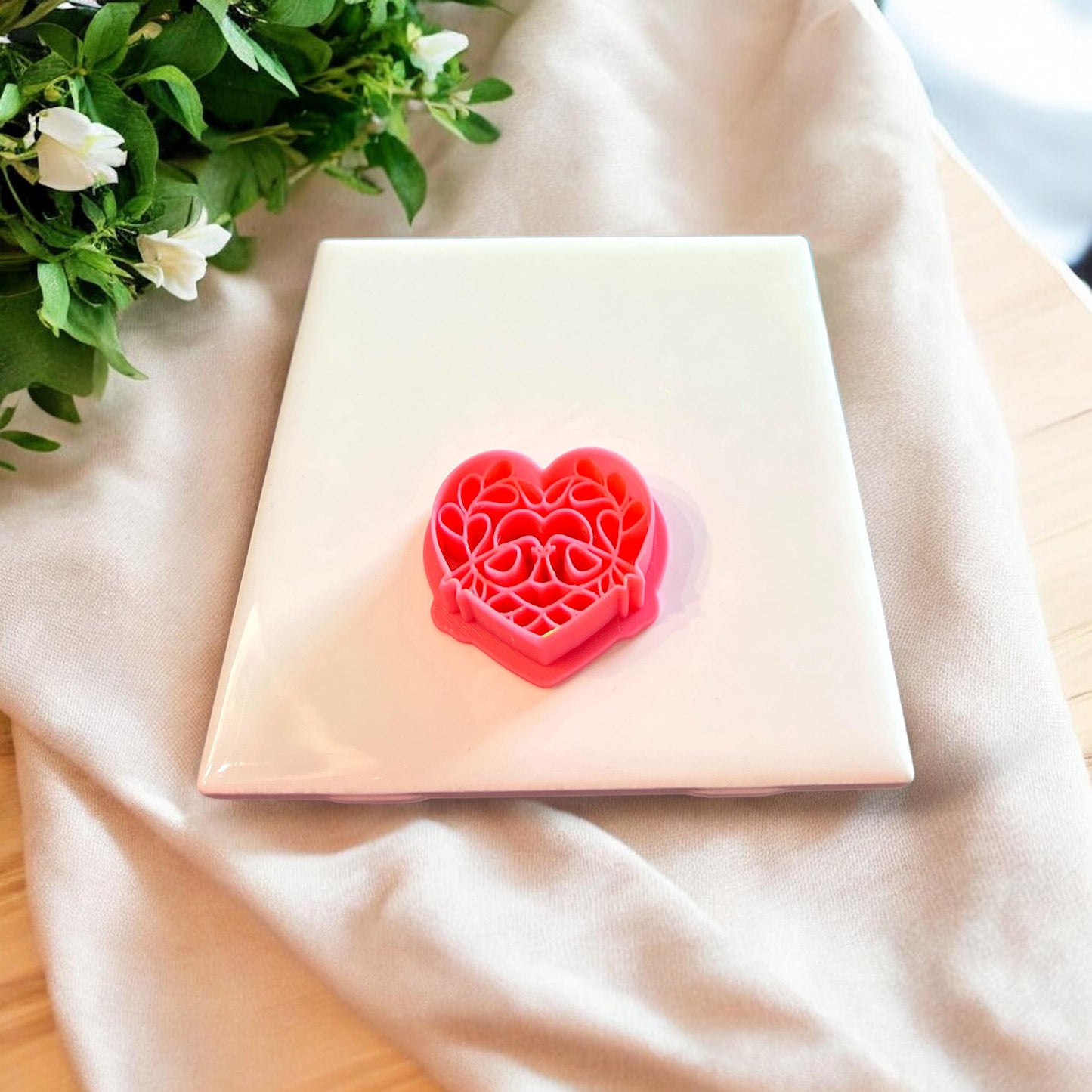 Close-up of the pink polymer clay cutter with love bird and floral detailing.
