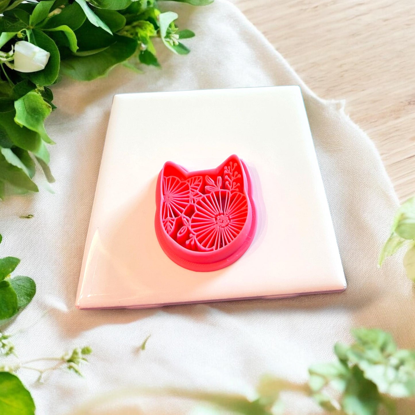 Side angle of the detailed floral kitty cutter, highlighting its precision and intricate design.