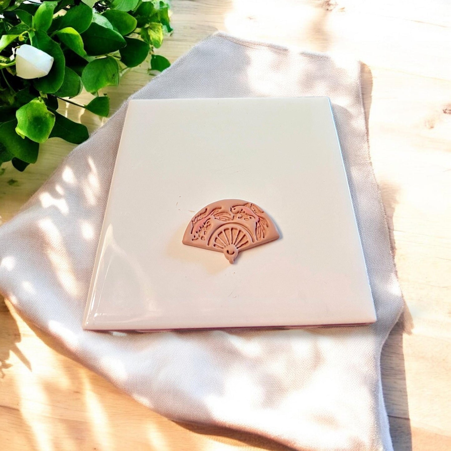 Close-up of finished koi fish fan shape cut from clay, showing clean lines and intricate design