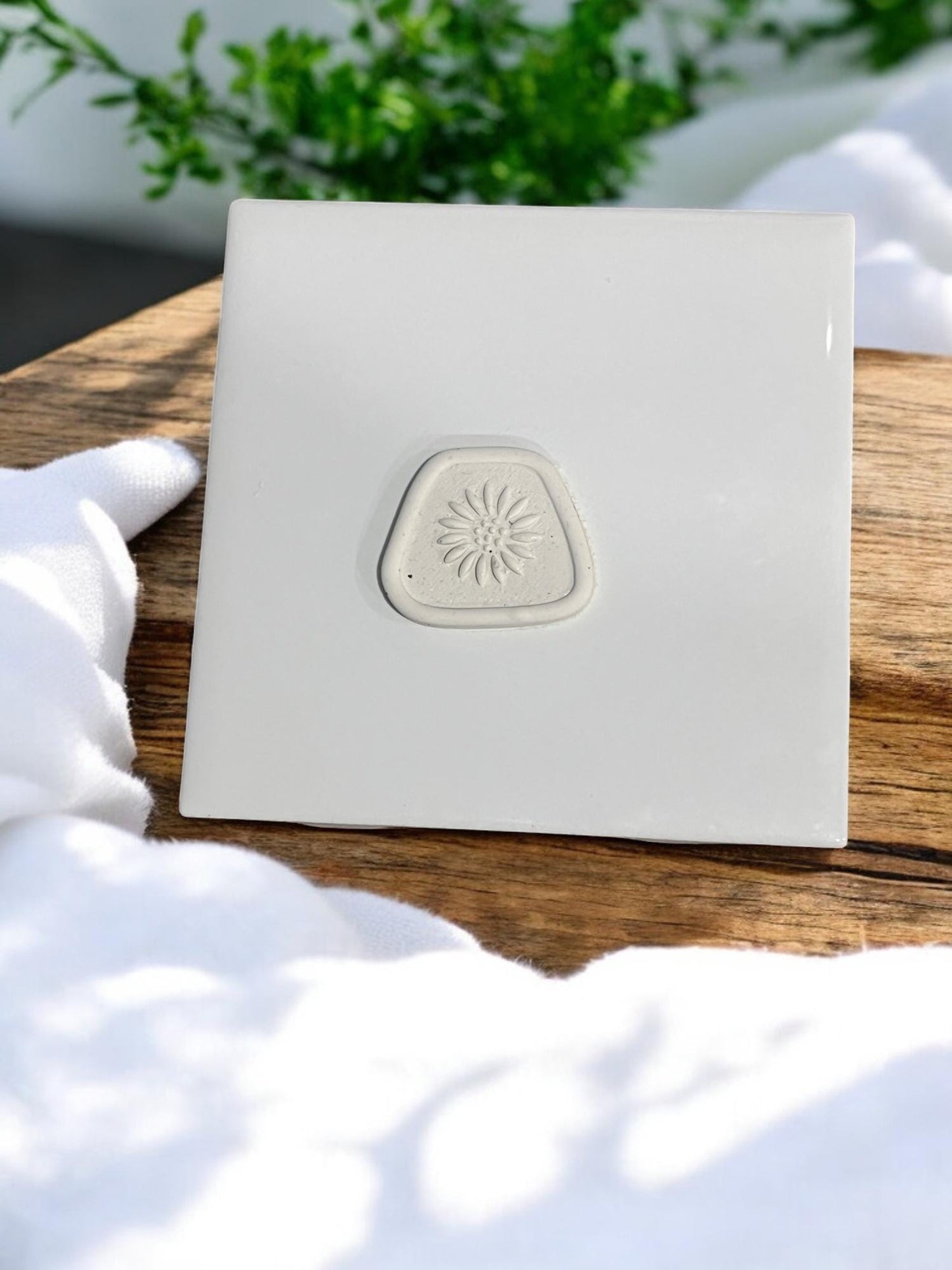 Finished sunflower impression on white tile