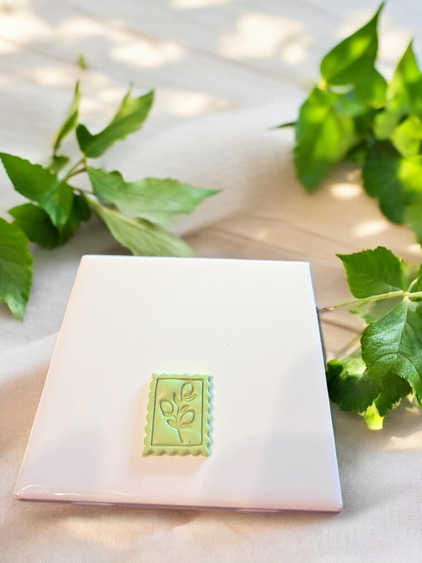 Leafy lemon design pressed into green polymer clay, perfect for seasonal earrings or charm accents.