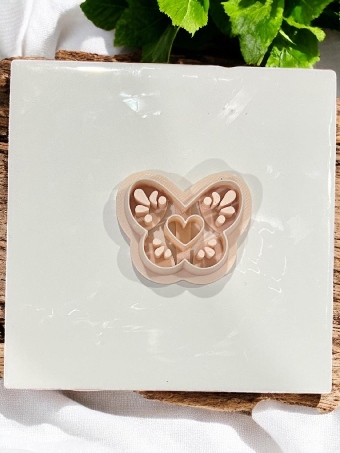 Full butterfly clay cutter shown on ceramic tile