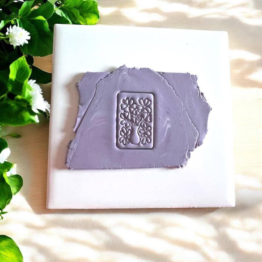 Polymer clay cutter shaped as flower bouquet in a vase, for floral earrings and jewelry crafting.