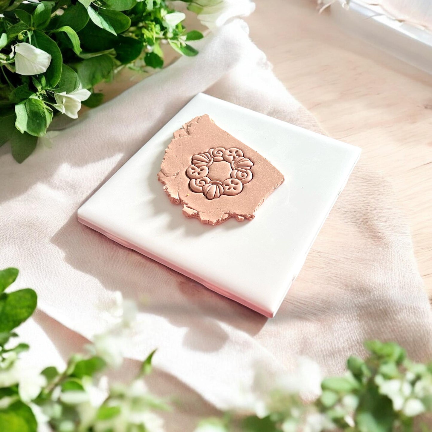 shell wreath design impressed in clay
