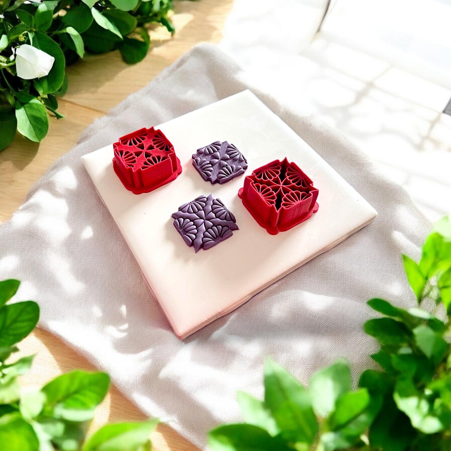 two purple clay pieces with matching red cutters