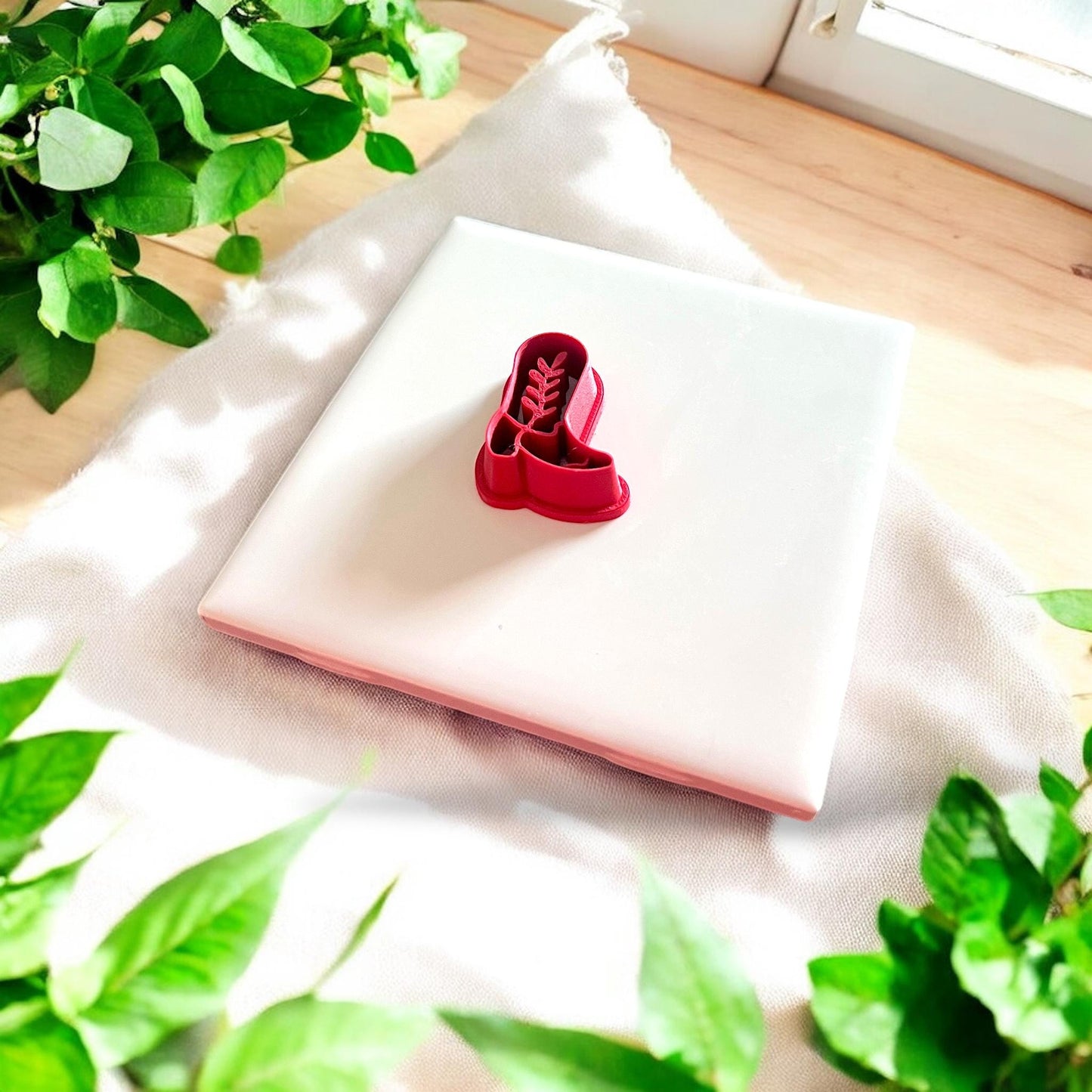 red cowboy boot polymer clay cutter on tile