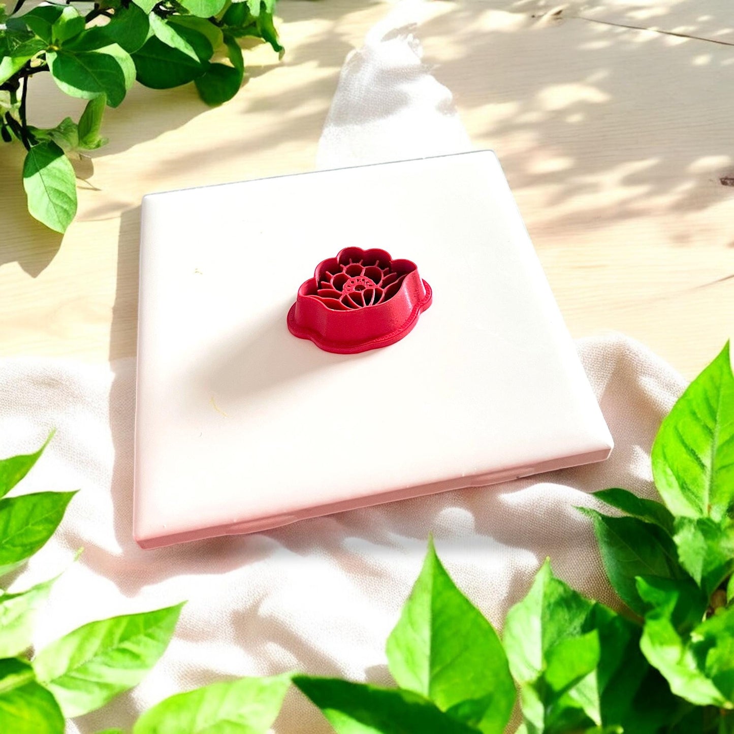 red polymer clay cutter with floral design