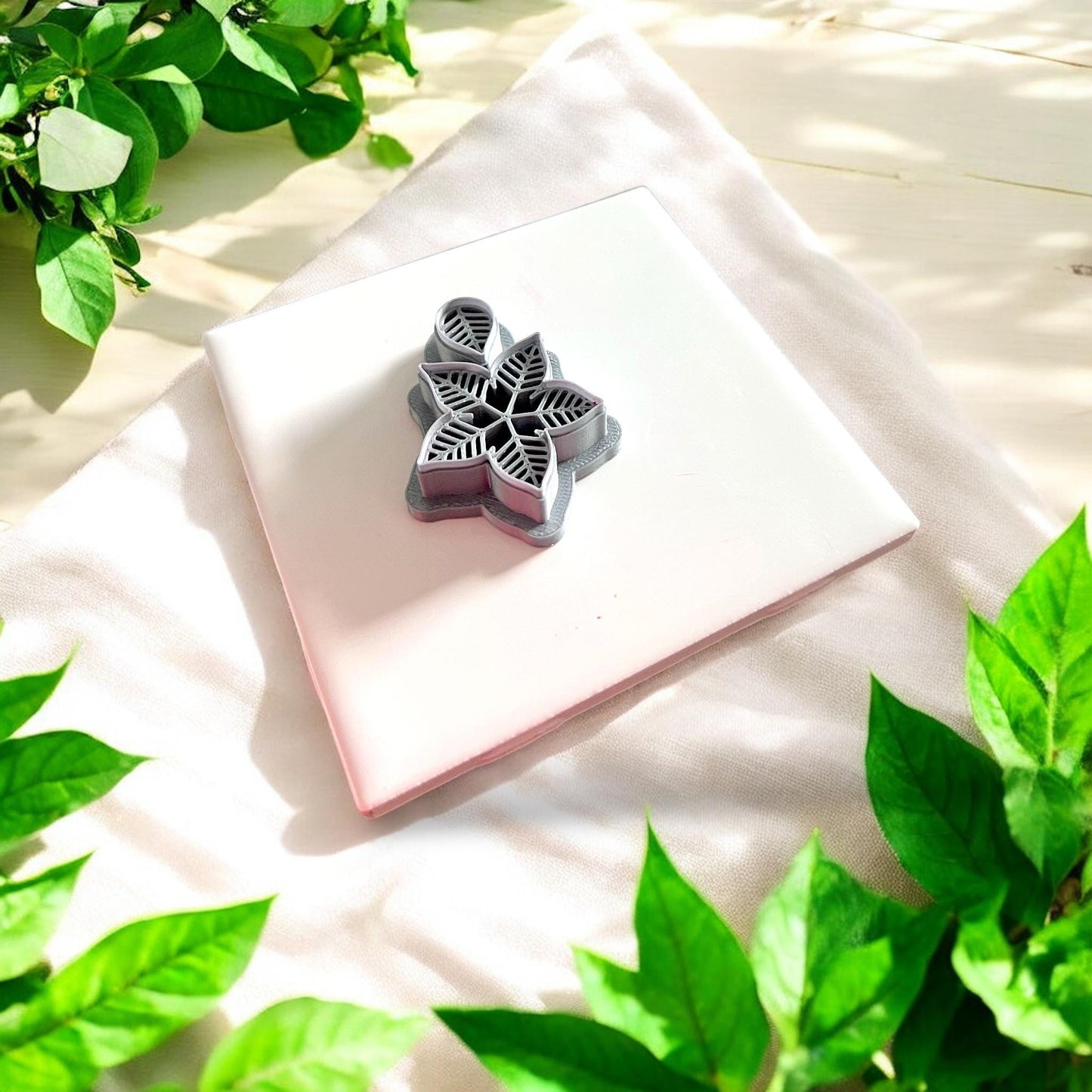 gray polymer clay cutter with leaf pattern