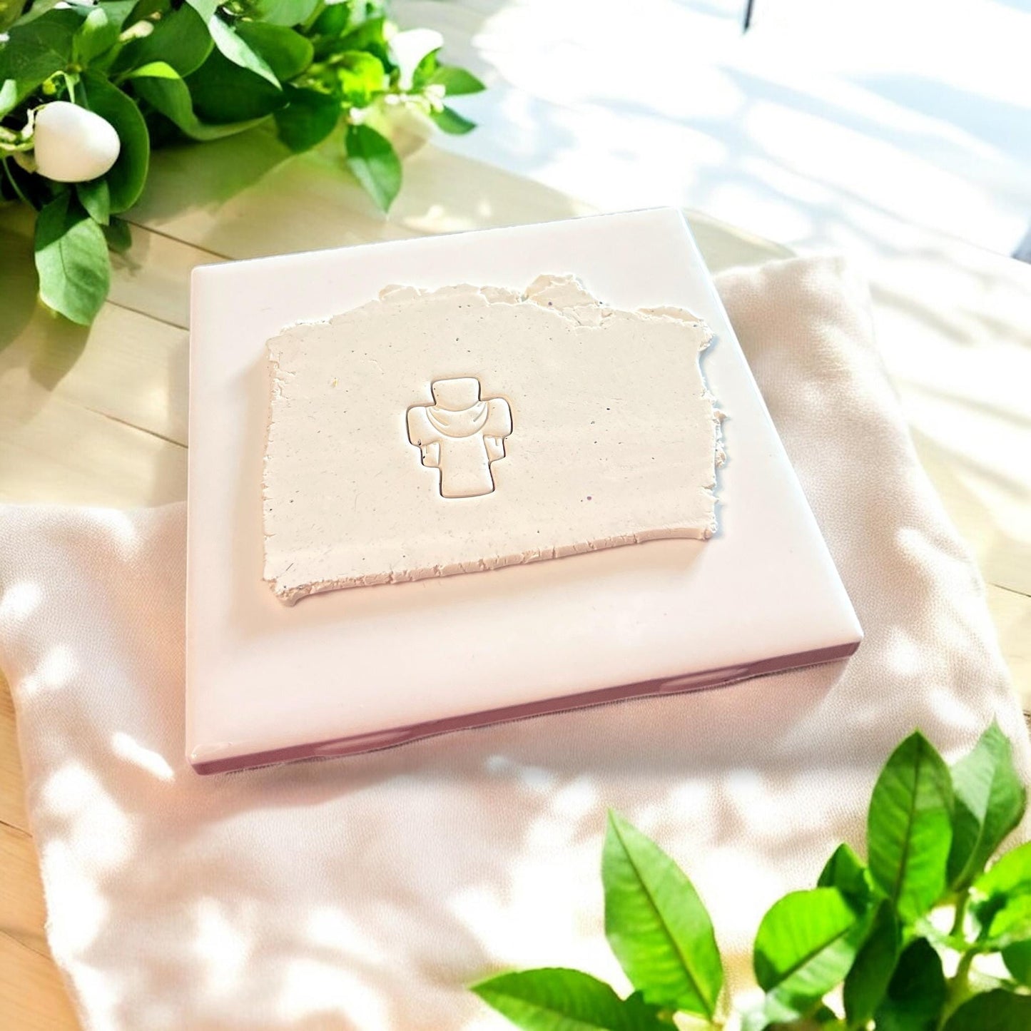 cross design embossed in clay