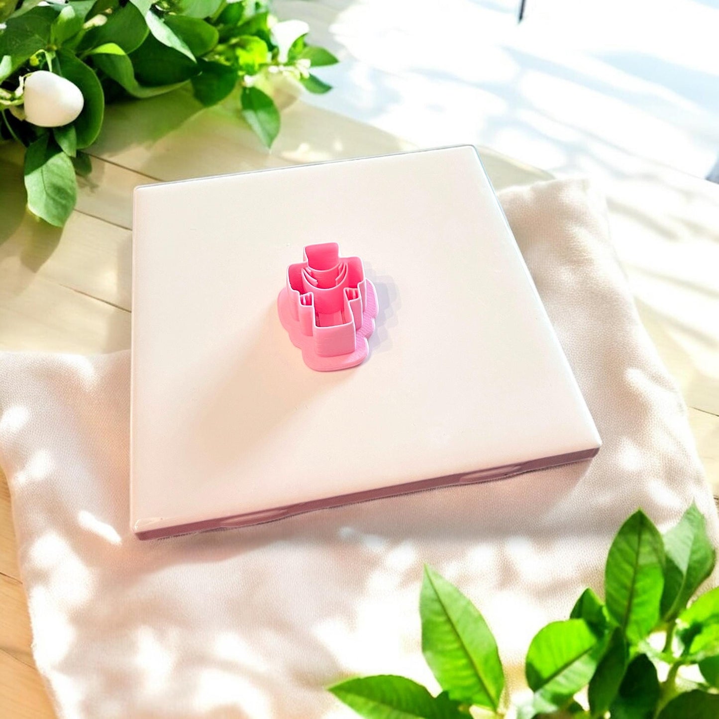 pink cutter with draped cross design