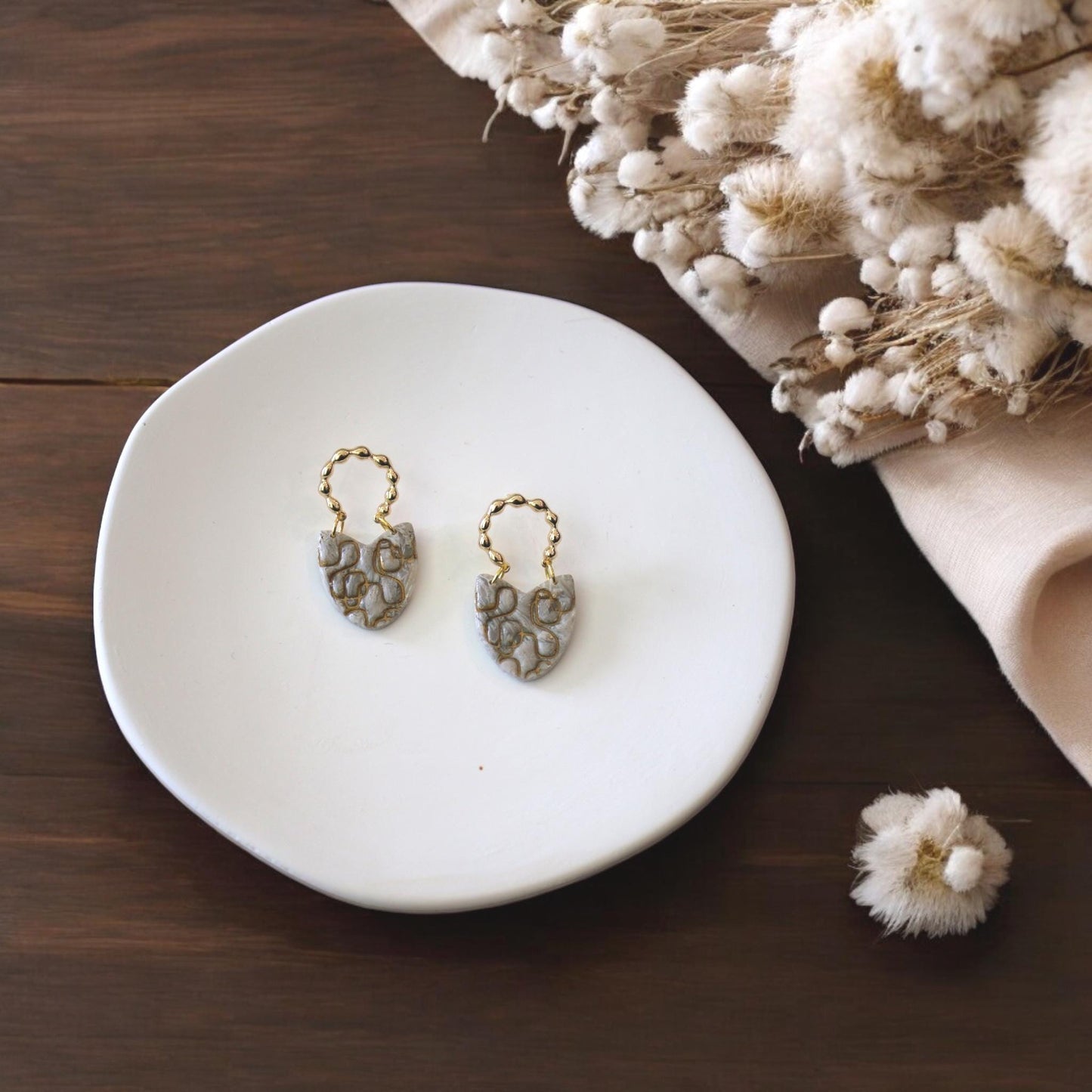 finished abstract earrings on tray
