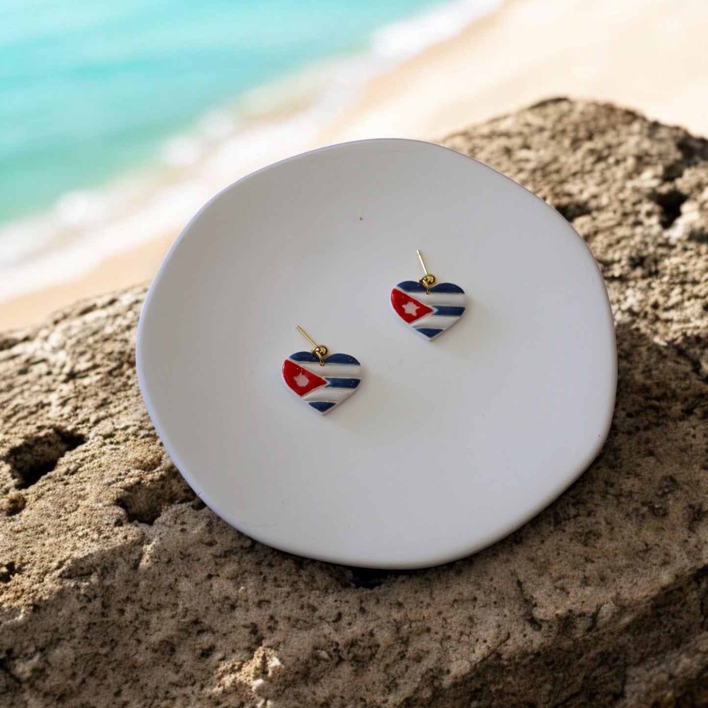 heart flag earrings on beach plate