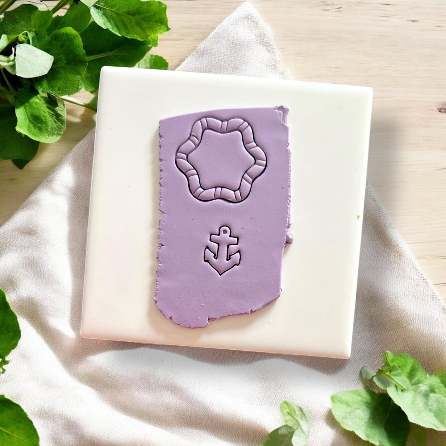 Purple polymer clay sheet with rope frame and anchor impression