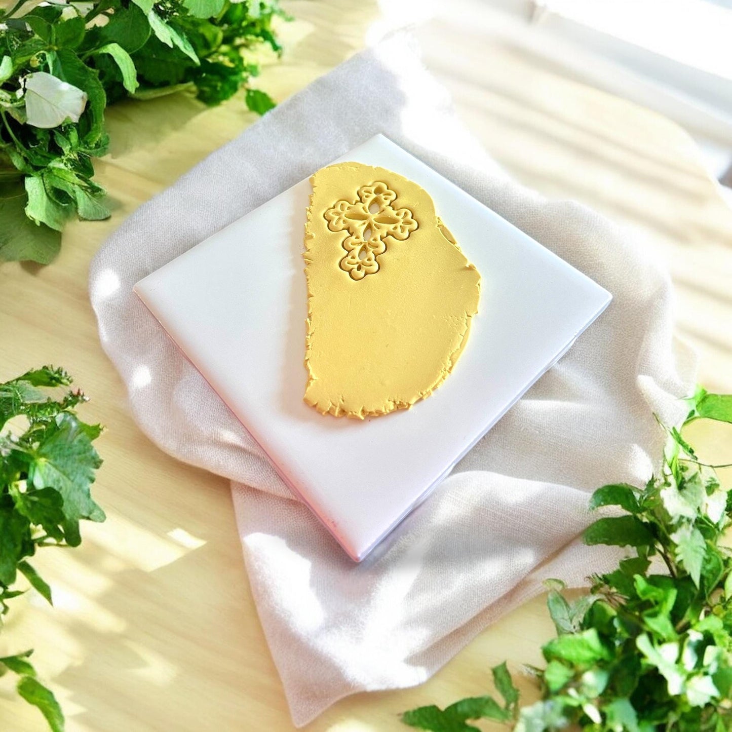 ornate floral cross imprint in yellow clay