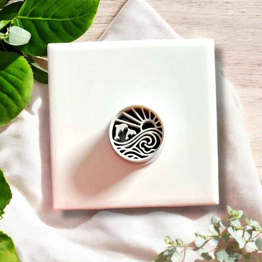 Round polymer clay cutter with dolphin and wave sun design