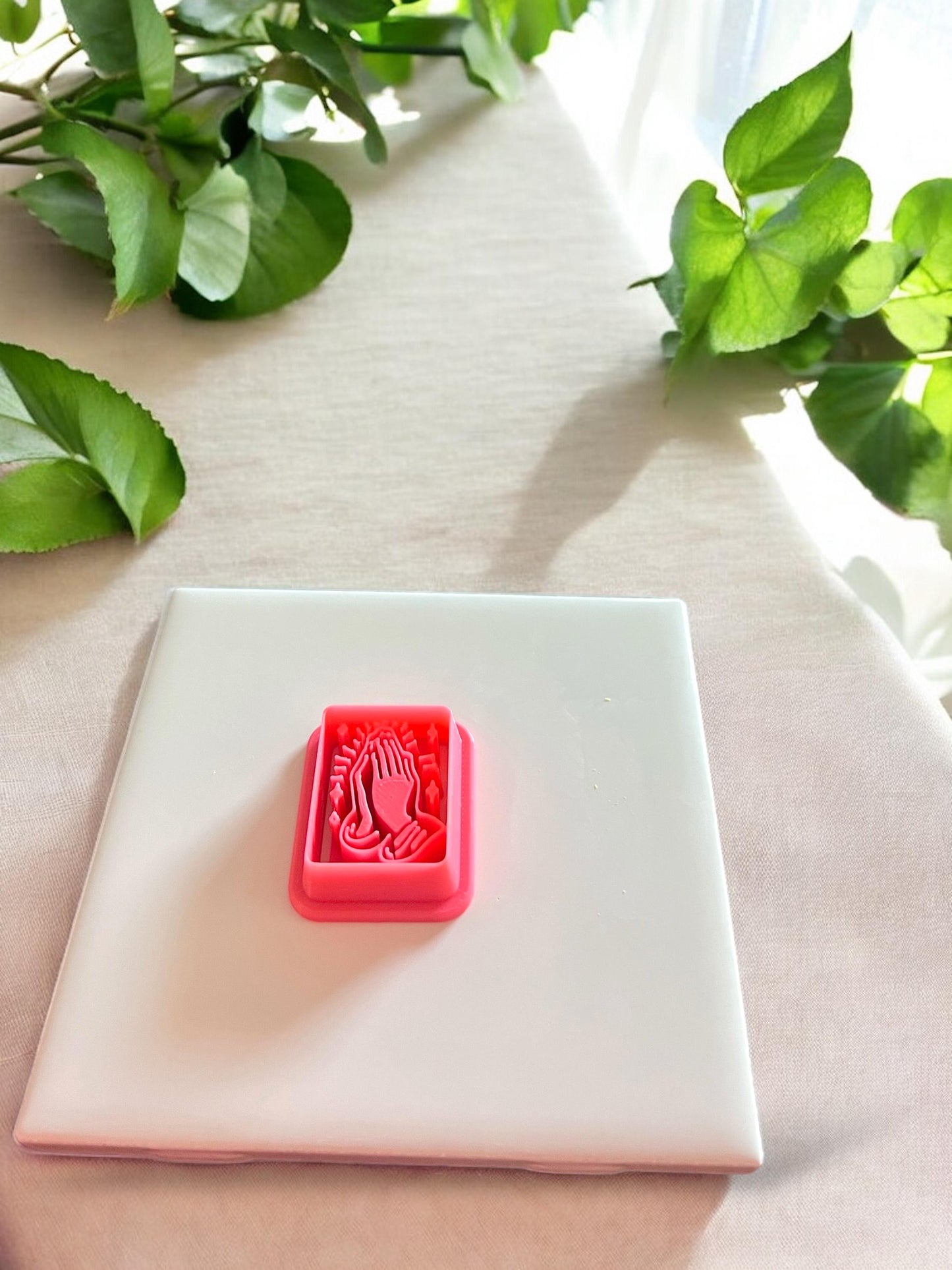Close-up of the rectangular praying hands polymer clay cutter showing intricate religious detailing and clean structure