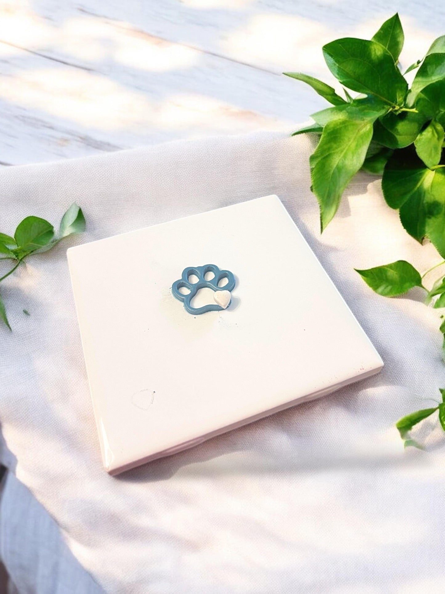 Delicate finished clay earring piece shaped like a paw print with a heart cutout in the center, perfect for dangle designs