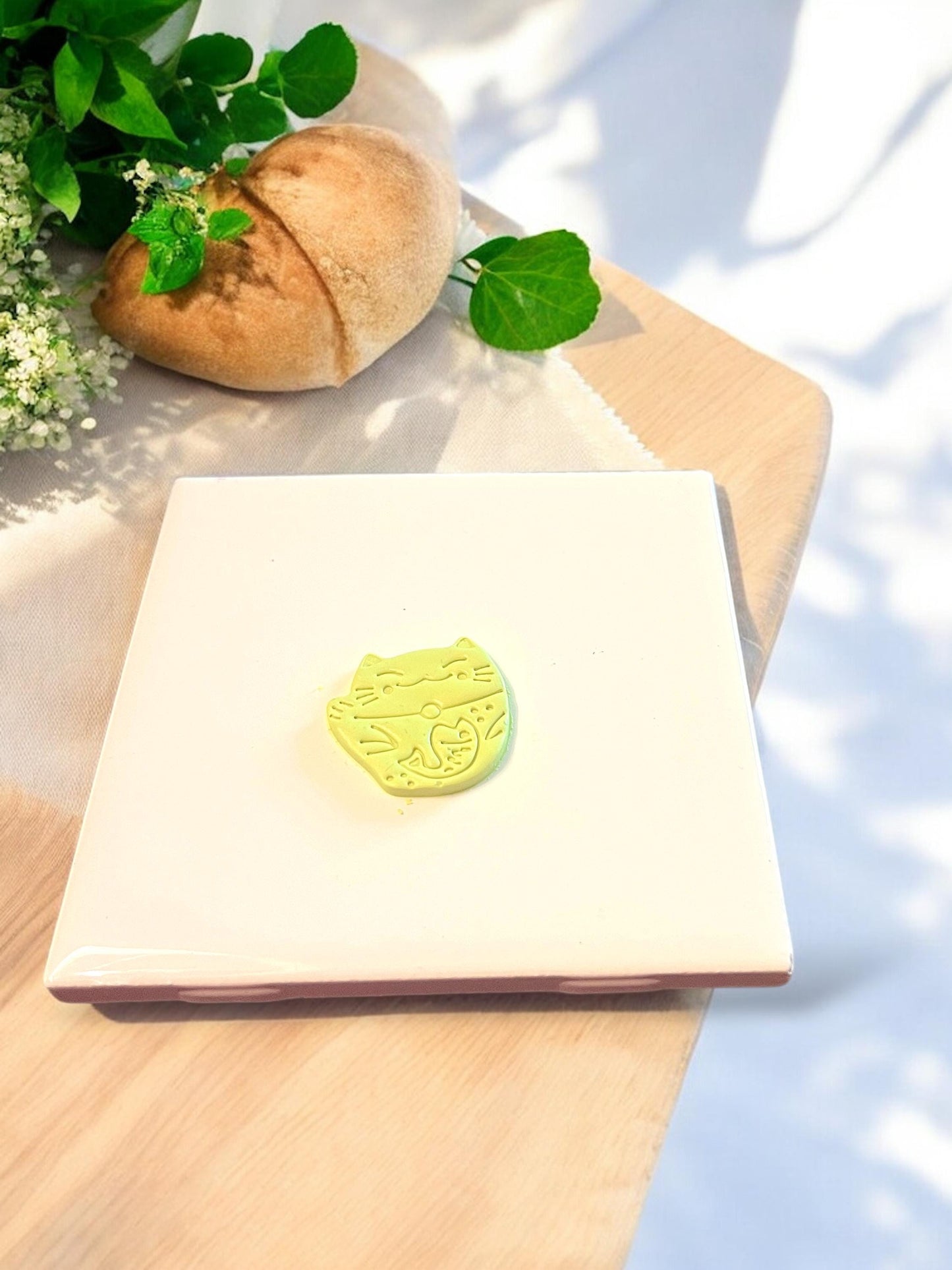 Cut clay piece shaped like a lucky cat for polymer clay dangles or charms