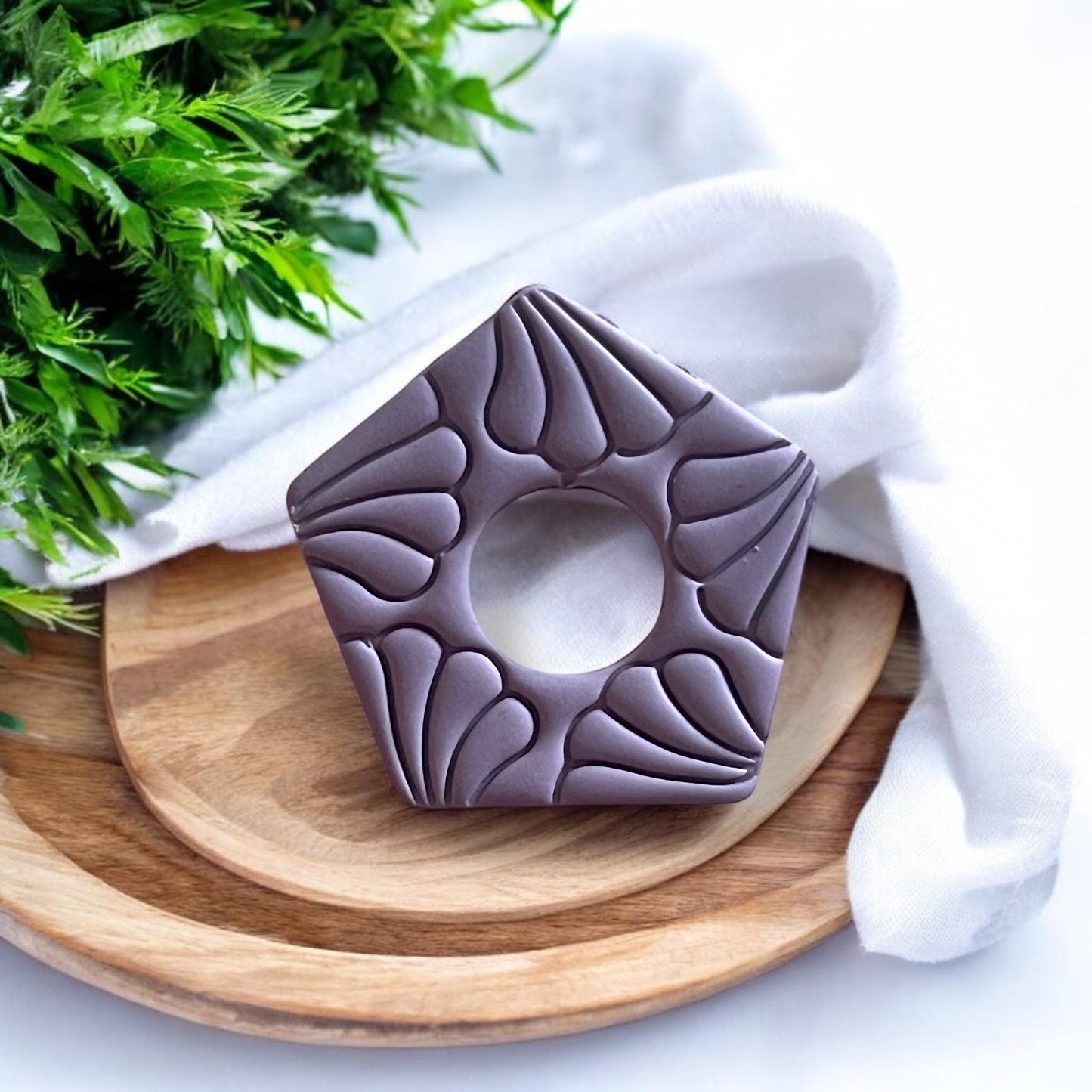 Close-up view of the floral motif polymer clay cutter, emphasizing the detailed craftsmanship.
