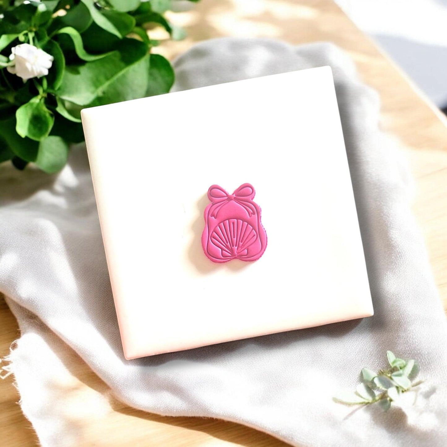 Polymer clay cut in a gift bag shape with seashell detailing, perfect for dangle earrings.