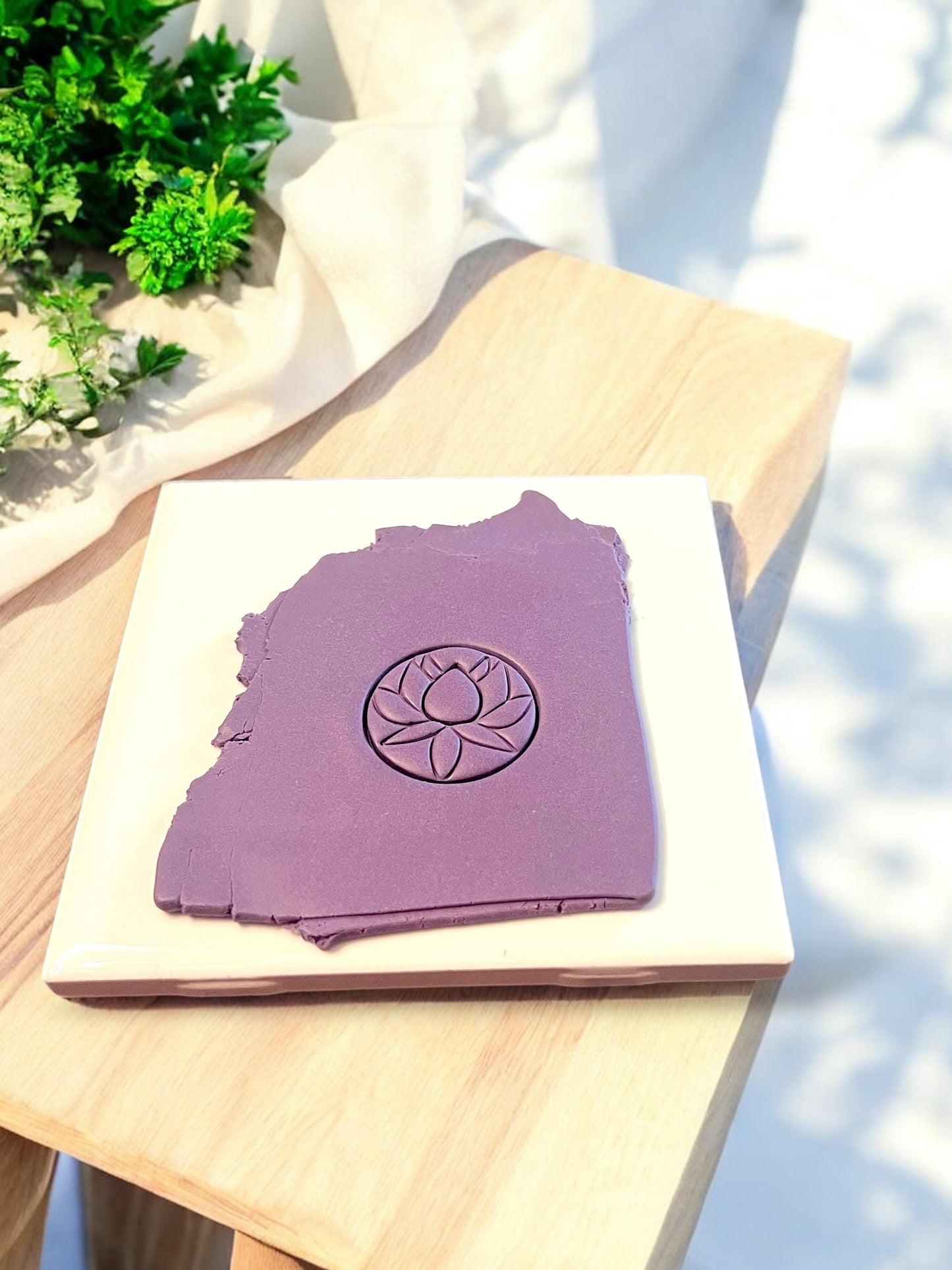 Polymer clay slab showing detailed lotus circle imprint made with clay cutter for earring dangles or jewelry making