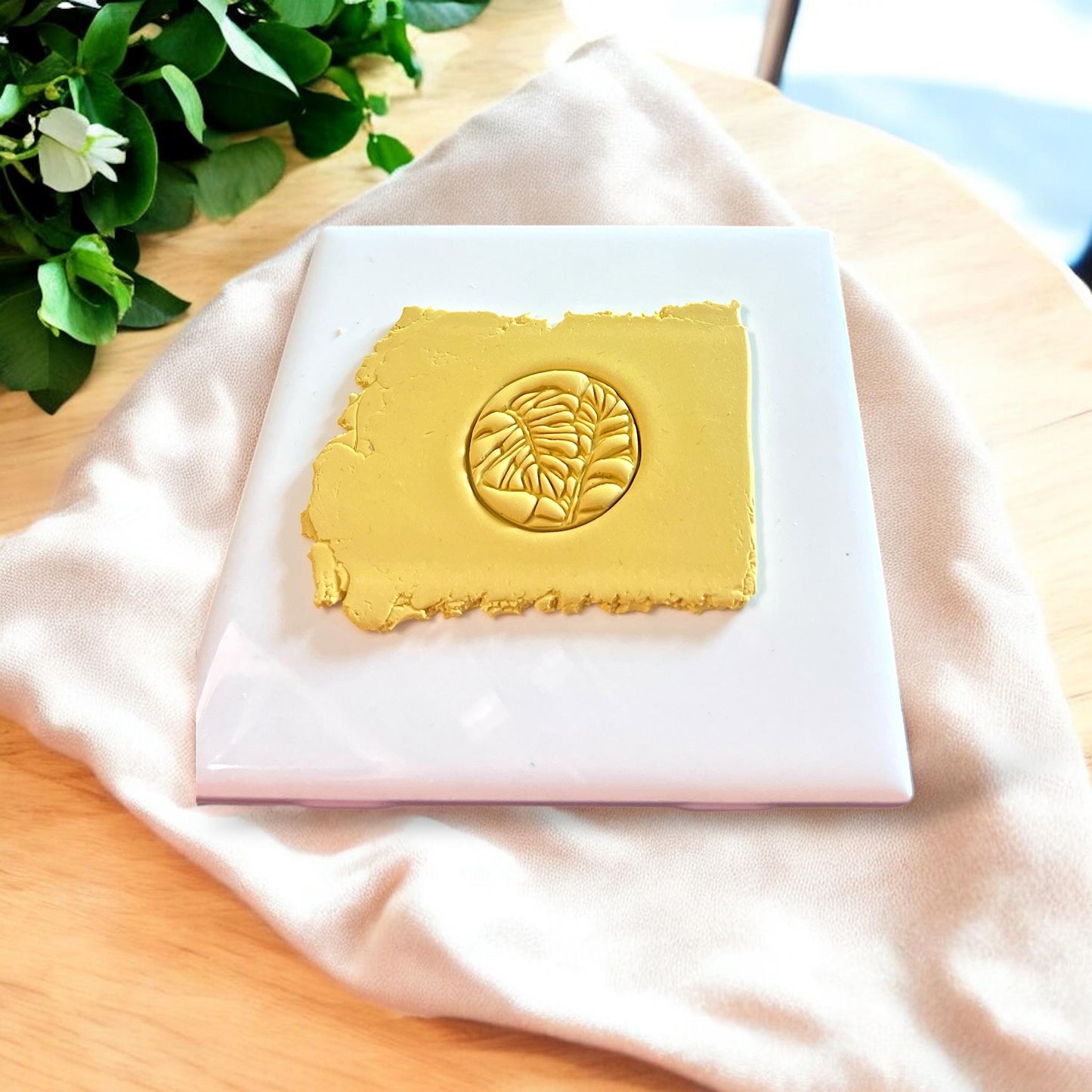 A plastic monstera leaf-shaped cutter designed for polymer clay jewelry making.