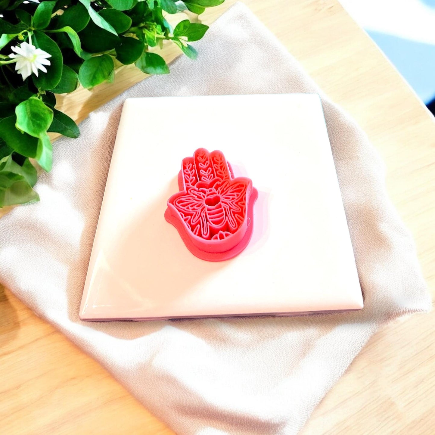 Top-down view of the hamsa clay cutter, ideal for spiritual craft projects.