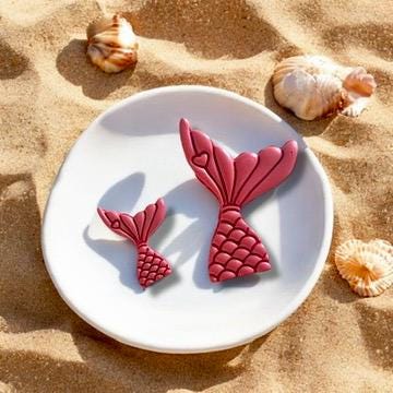 Completed earrings made from the mermaid tail cutter, displayed on a neutral background.